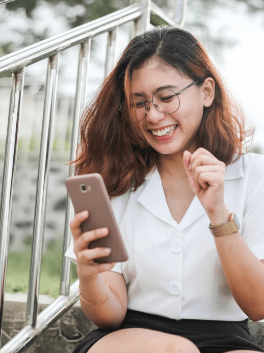 Woman excited looking at her phone
